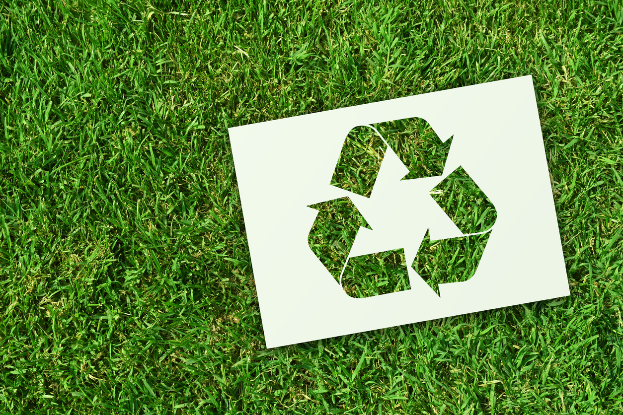 Recycling symbol on grass