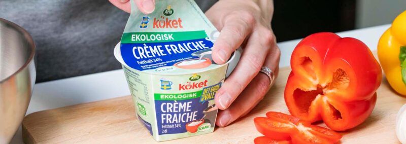 Opening lid on a Arla Creme Fraiche cup