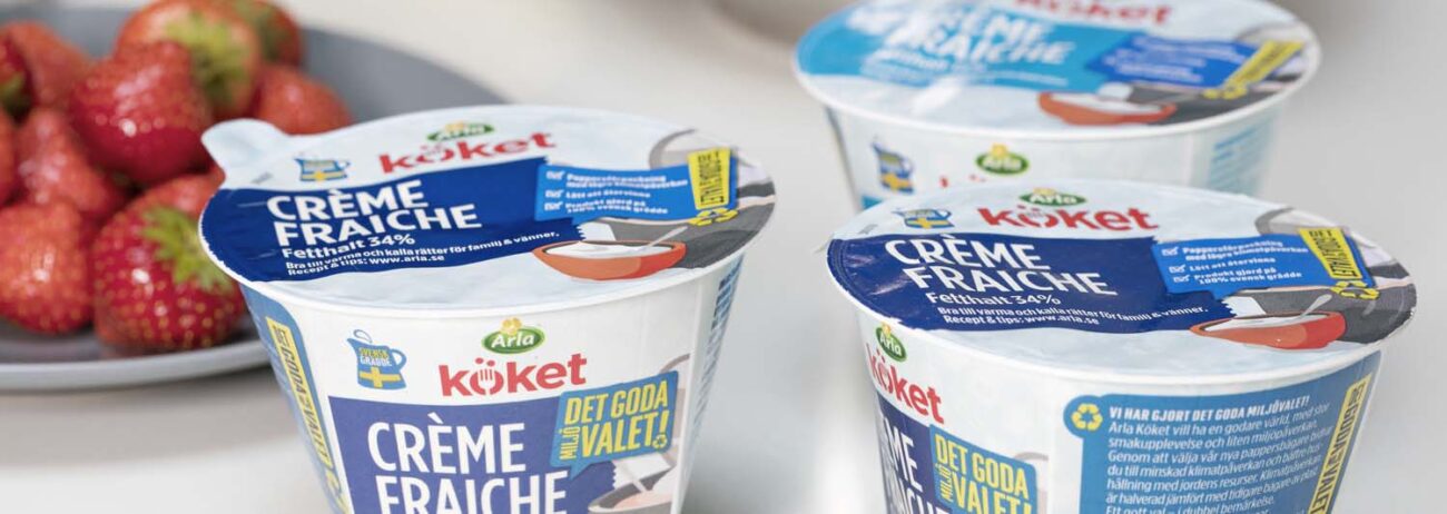 Arla jogurt cups with paper Lids on a table